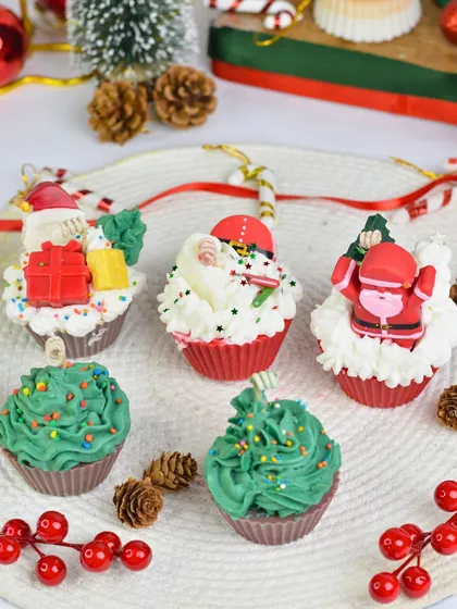 These Christmas cupcake candles are almost too cute to light. Topped with Santa and tree designs, they are a sweet addition to your holiday decor.