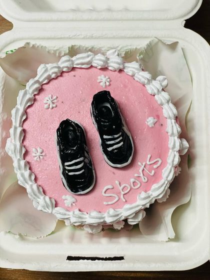 A sporty bento cake with tiny sneakers, perfect for a fitness enthusiast.