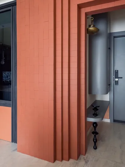The entrance foyer is designed to feel grand and welcoming. Clad in clay brick tiles, it sets a warm, earthy tone right from the start.