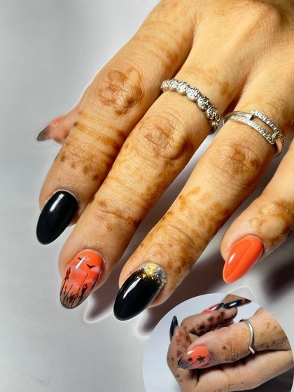 A creative Halloween-themed nail set with a sunset, bats, and spiderwebs. This work from a seminar student shows their ability to create fun, thematic art.
