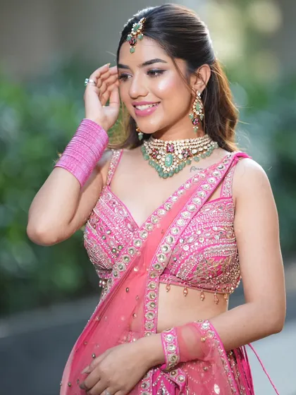 A closer look at this stunning emerald and zircon choker set against a vibrant pink lehenga. The contrast of colors makes this a true statement piece for any modern bride or bridesmaid.