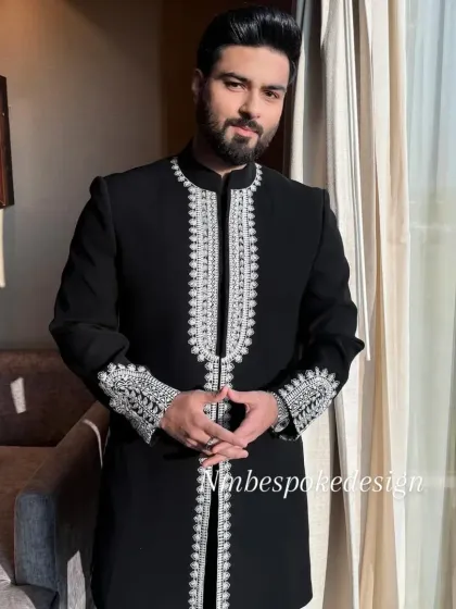 A black indowestern jacket with intricate silver embroidery along the front opening and cuffs, perfect for a sharp, formal ethnic look.