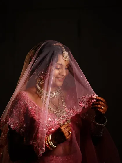 Another beautiful, shy smile from the bride under her veil. The focus is on her expressive eyes and glowing skin, key elements of my makeup philosophy.