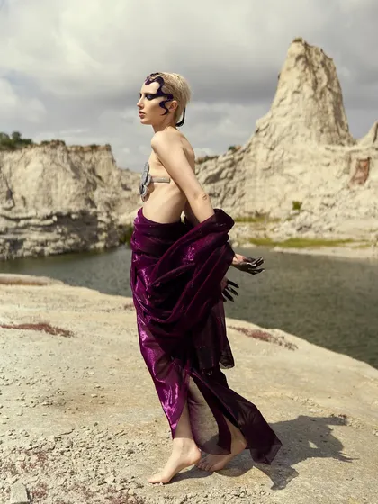 The movement of the purple fabric complements the flow of the sculpted hair in this shot from the 'Siren' series.