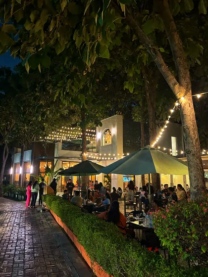 The cafe patio at night, with string lights creating a warm and inviting space.