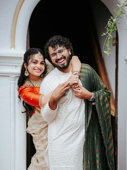 A joyful and candid moment of the couple sharing a laugh, their happiness is infectious in this engagement portrait.