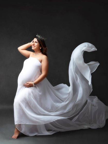 Every mother is a queen. I love using simple props like this crown with a flowing white gown to create regal and empowering maternity portraits in the studio.