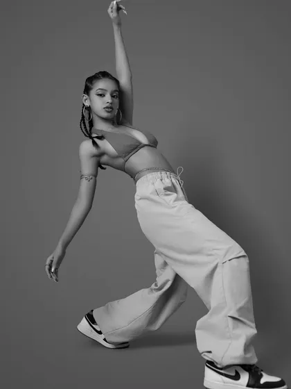 A black and white image with an extended arm, creating a long, graceful line. This highlights the artistic and statuesque quality of my poses.