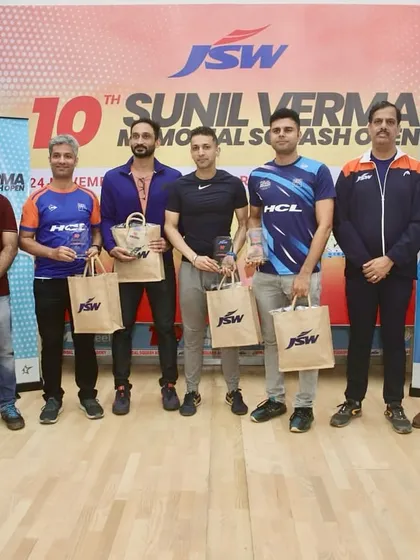 On the podium at the JSW Sunil Verma Memorial Squash Open. It's important for coaches to stay competitive to better understand what our players experience.
