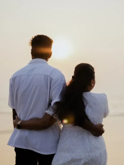The couple looks out at the sunset together, a symbolic and peaceful moment captured during their pre-wedding shoot.