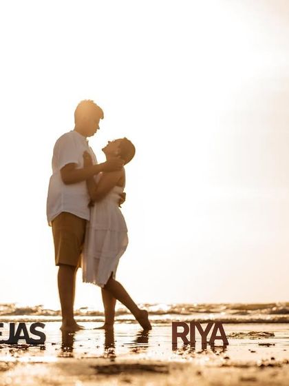 A playful and romantic silhouette during golden hour, with custom name props to personalize the moment. This is a fun addition to any beach pre-wedding shoot.