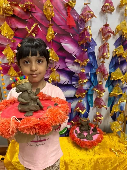 This student is ready for the festivities with her two handmade Ganesha idols.