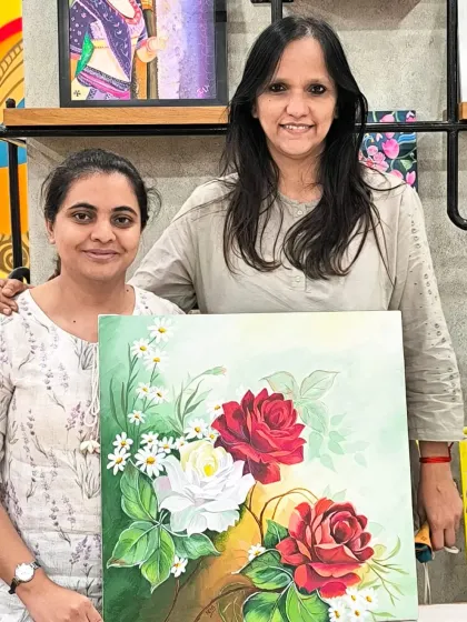 A student and I pose with her beautiful floral painting of red and white roses, a classic composition she mastered in my class.