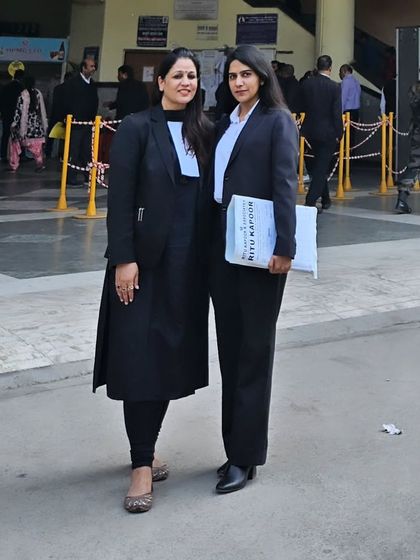 With a junior advocate outside the court entrance. Mentoring young lawyers is a part of my commitment to the legal profession.