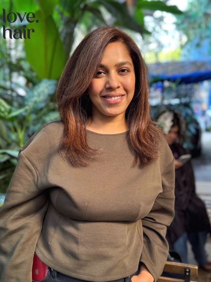 The happy client reveal of her mahogany glaze transformation. The warm, reddish-brown tones beautifully complement her skin tone.