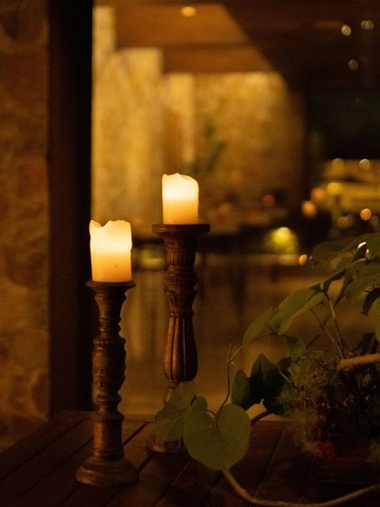 The warm glow of candles sets the mood for an intimate evening by the pool.