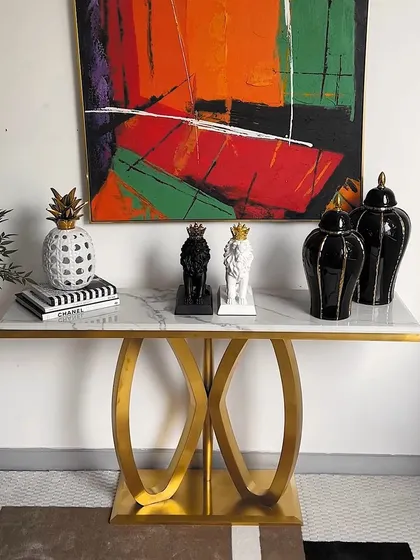 The same console table, styled in a second way. This demonstrates how easily you can change the entire feel of the piece just by swapping out the decor. The gold base and marble top work with any color palette.