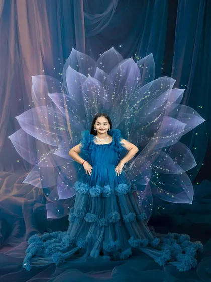 Bold and beautiful. This dramatic maternity portrait in a stunning blue gown with an artistic floral background celebrates the strength and grace of motherhood.