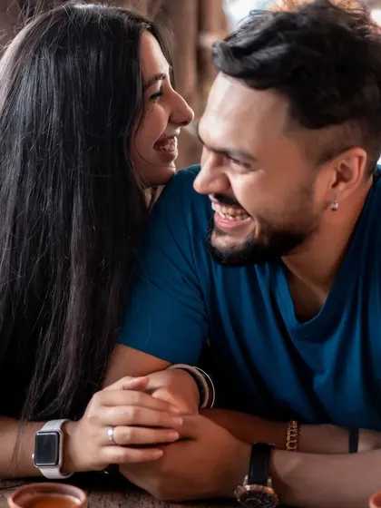 A close-up of the couple sharing a heartfelt laugh over a cup of tea. It’s a simple, everyday moment that is filled with so much love.