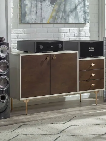 A classic high-fidelity setup featuring Bowers & Wilkins tower speakers powered by a Rotel integrated amplifier, delivering exceptional two-channel audio for music lovers.