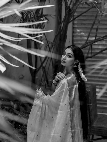 A black and white portrait looking over my shoulder, framed by foliage.