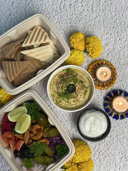 The complete Pita Hummus meal, including a vibrant salad with a lime wedge for that extra zing. It's a healthy and delicious option for your party.