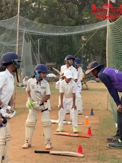 A group of young girls in full gear, listening intently to their coach's instructions. We focus on building strong technical skills from the very beginning.