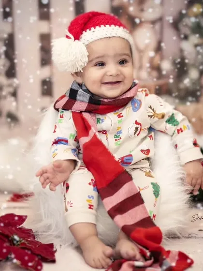 Ho ho ho. How about a cute little Santa for a change? This baby's happy face and festive outfit make for a perfect holiday card photo.