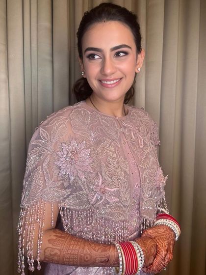 Another shot of this sweet and simple reception look, showing the beautiful cape detail and natural makeup.