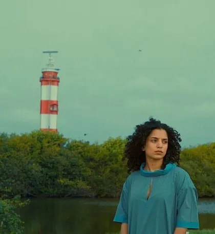 A striking shot from the "Made to Move" video, with a model in front of a lighthouse. The makeup was kept clean and minimal to suit the scenic backdrop.