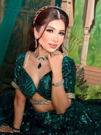 A close-up of the soft green party makeup. The focus is on the flawless skin and the subtle shimmer on the eyes.