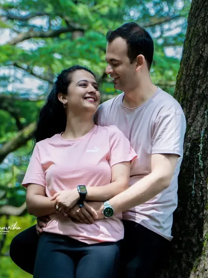 A happy, candid moment between the couple. The natural greenery of the forest provides a perfect, serene backdrop for this pre-wedding picture.