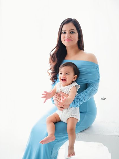 A beautiful portrait of a mother and her happy baby. Her smile says it all!