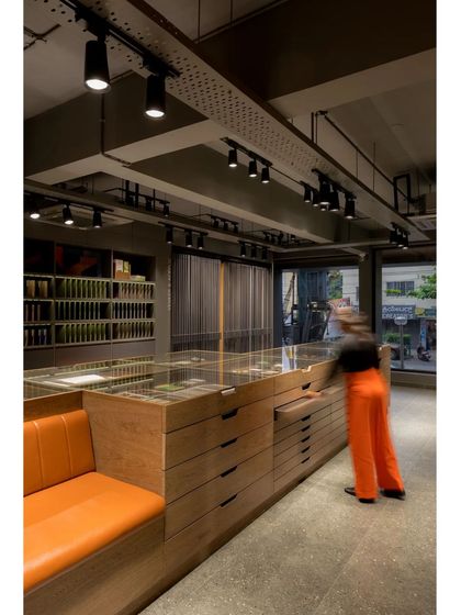 The showroom in action, with a team member accessing the extensive sample library stored in the central island.