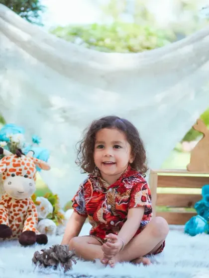A happy and relaxed toddler enjoying the fresh air. Outdoor shoots are great for capturing genuine smiles and playful energy.