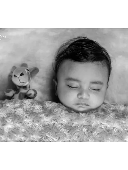 There is a timeless elegance to a black and white portrait. This style emphasizes the soft textures and peaceful expression of a sleeping baby, creating a beautiful piece of art that focuses purely on your little one.
