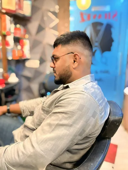 A side view of the high skin fade, showing the smooth transition from the skin to the longer hair on top. Precision is key for this style.