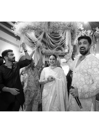 Sona and Zaheer defy convention, and their wedding was a testament to their love. Here, Sona makes her entry under a phoolon ki chaadar held by her closest friends, a moment of joy and support.
