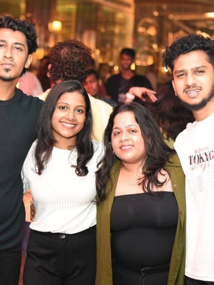 A group of friends posing for a picture at Maize and Malt. It's a great spot to hang out and enjoy the weekend.