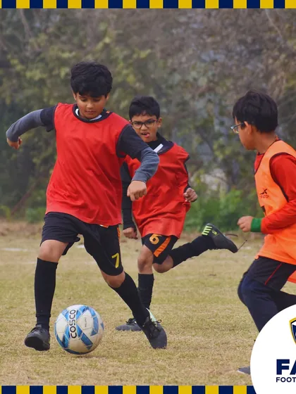 Young players in action during a training match, learning to work together as a team.
