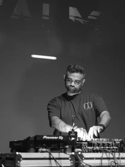 A stark, black and white photo of me focused on the mixer, with my name projected on the screen behind.