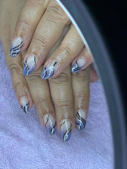 A cool abstract design with black and silver glitter swirls on a sheer grey base.