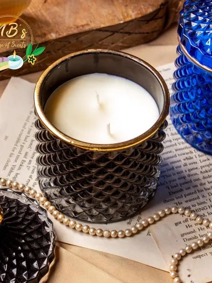 This close-up shows the detail of my two-wick soy candle in a black crystal jar. The golden rim adds a touch of royalty, making it a perfect gift for a special occasion or a treat for yourself.