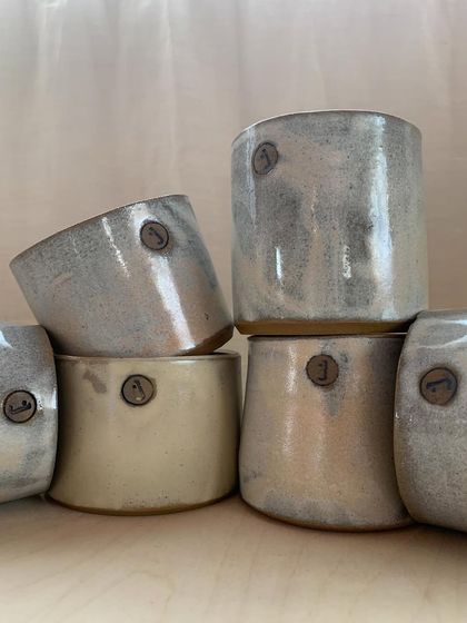 These cups were made especially for my studio, stamped with our logo. They hold our tools and brushes, and seeing them every day feels like home.