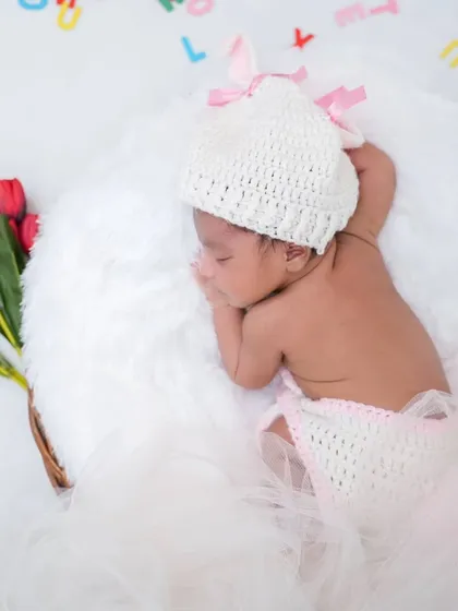 A sleeping beauty with a bouquet of tulips. This classic, clean setup creates a pure and angelic portrait.