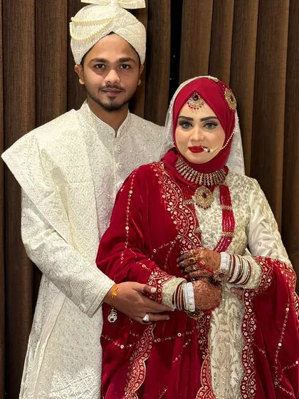 The happy couple posing for a photo. The bride's makeup is flawless and radiant, a perfect look for her Nikkah day.