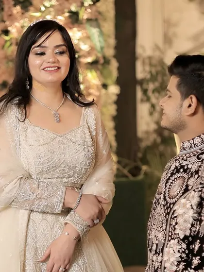 A candid moment between the happy couple, her natural makeup look perfect for this daytime engagement event.
