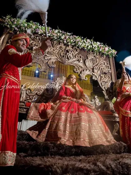 The bride makes her royal entrance on a palanquin, attended by performers with traditional 'chawar' fans. This adds an authentic, historical touch to her majestic procession.