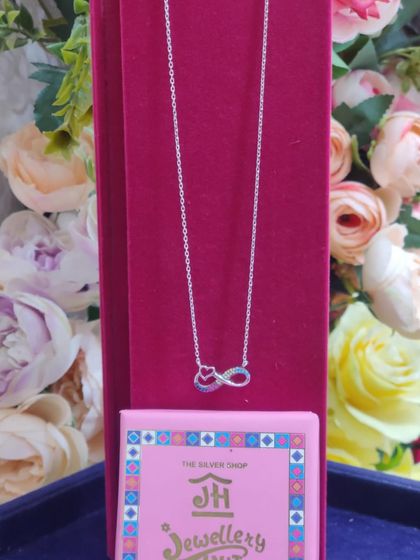 An infinity symbol intertwined with a heart, this sterling silver necklace is a beautiful representation of eternal love.