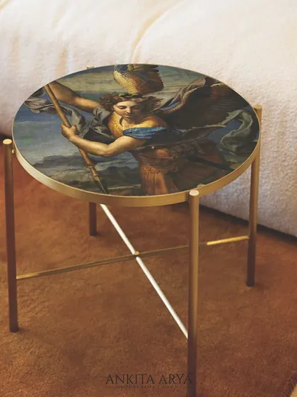 The printed glass side table placed in a cozy setting. The artwork adds a touch of drama and sophistication, redefining the role of a simple furniture piece.